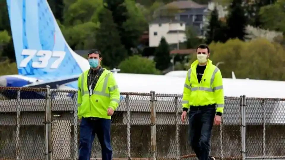Boeing workers wear masks at the Boeing Renton Factory, where 737 MAX airliners are manufactured, as commercial airplane production resumes following a suspension of operations last month in response to the coronavirus pandemic.
