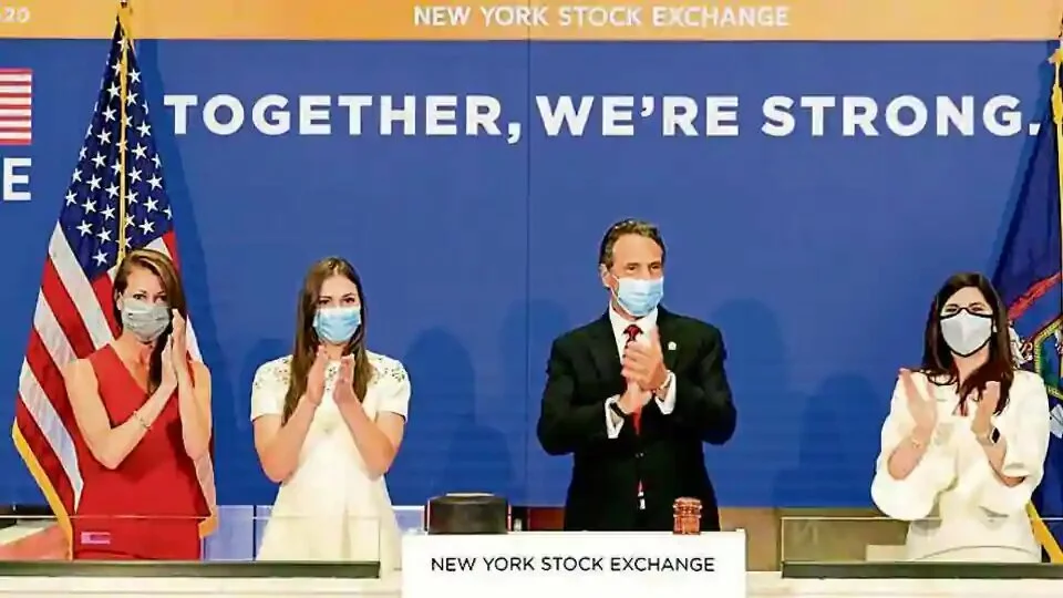 New York State Governor Andrew Cuomo (centre) applauds as he rings the opening bell of the New York Stock Exchange with NYSE president Stacey Cunningham (right) on Tuesday.