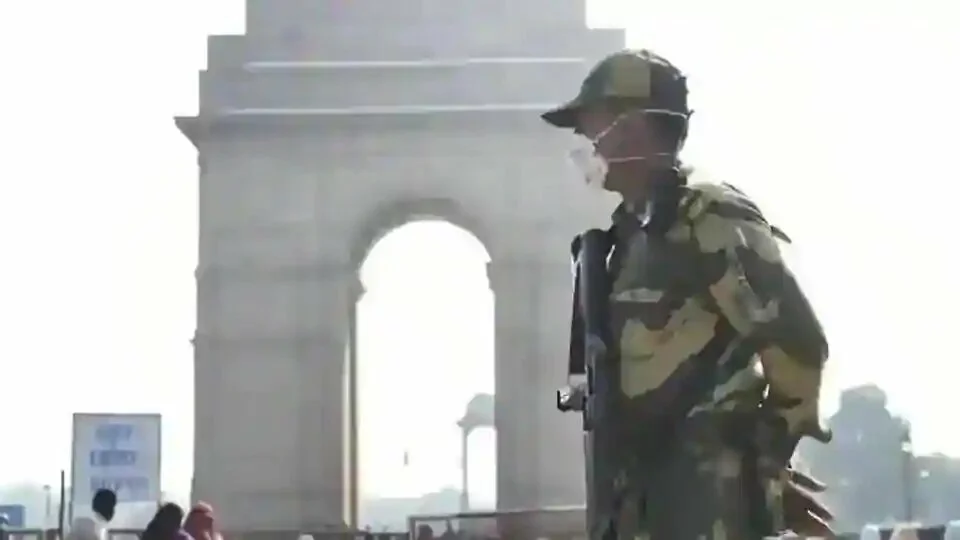A BSF personnel is seen wearing protective face masks amid rising coronavirus concerns at India Gate in New Delhi.
