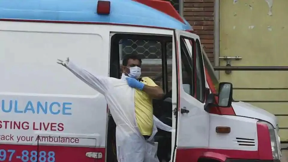 A driver gets into a PPE suit, outside the Covid-19 ward, during lockdown, in LNJP hospital, New Delhi.