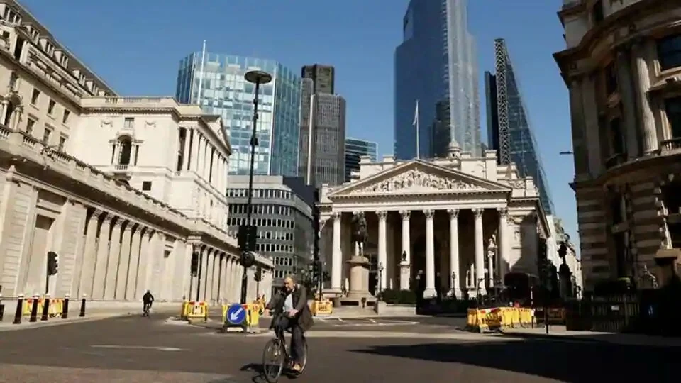FILE PHOTO: A cyclist is seen infront of the Bank of England as the spread of the coronavirus disease (COVID-19) continues, London, Britain, April 14, 2020. REUTERS/John Sibley/File Photo
