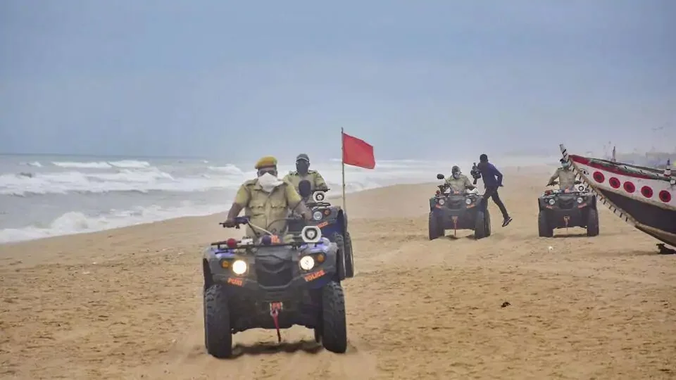 Marine police personnel patrol Puri beach to prevent tourists and fishermen from venturing into the sea due to Cyclone Amphan.