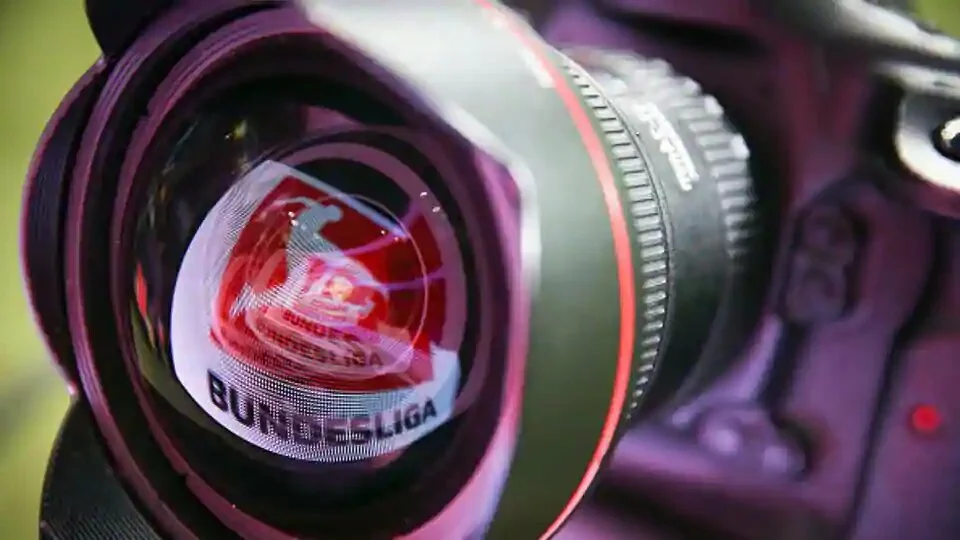 A LED board showing the Bundesliga logo is reflected in a lens prior to the Bundesliga match.