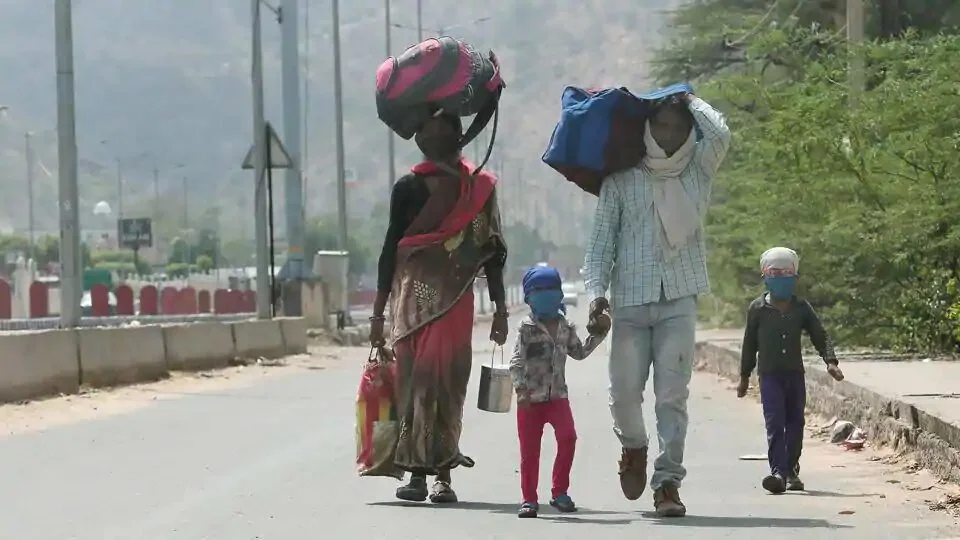 A migrant laborer, 25 year old Naresh and his 8 month pregnant wife Malti along with son Pradeep and daughter Tanu, while walking towards their home in Chhatarpur district of Madhya Pradesh, on Agra highway during third phase of Lockdown due to corona pandemic, in Jaipur on Thurssday, 14 May 2020.