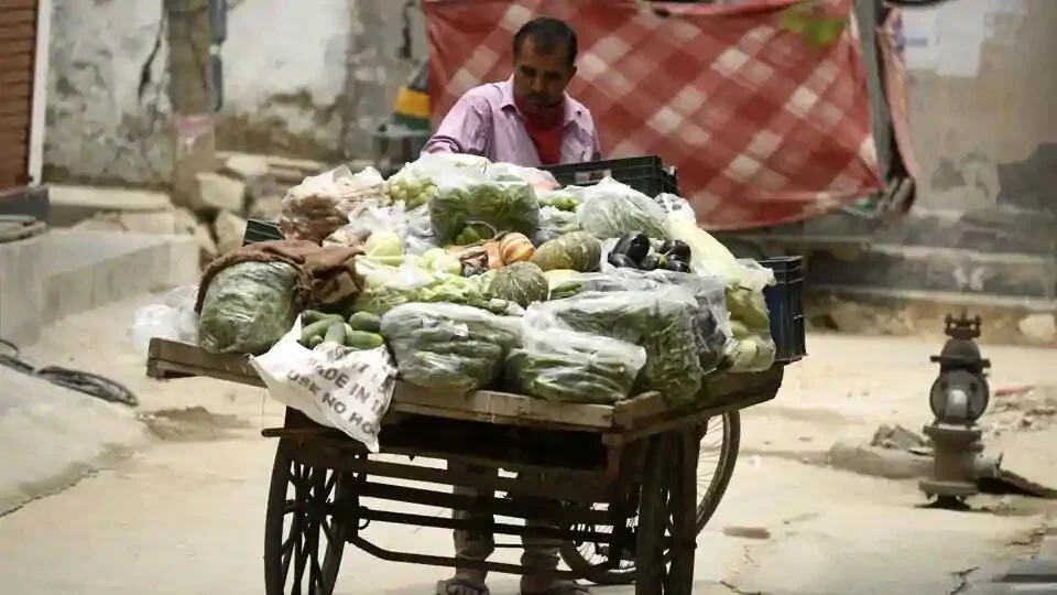A vegetable vendor selling produce on a cycle cart makes the rounds in the Om Nagar coronavirus containment zone during lockdown in Sector-11 near National Highway-48, in Gurugram.