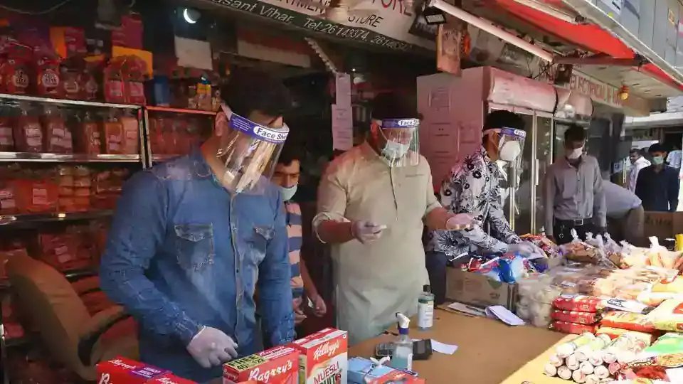 Shopkeepers and staff wearing face shields at a departmental store in Vasant Vihar market, New Delhi.