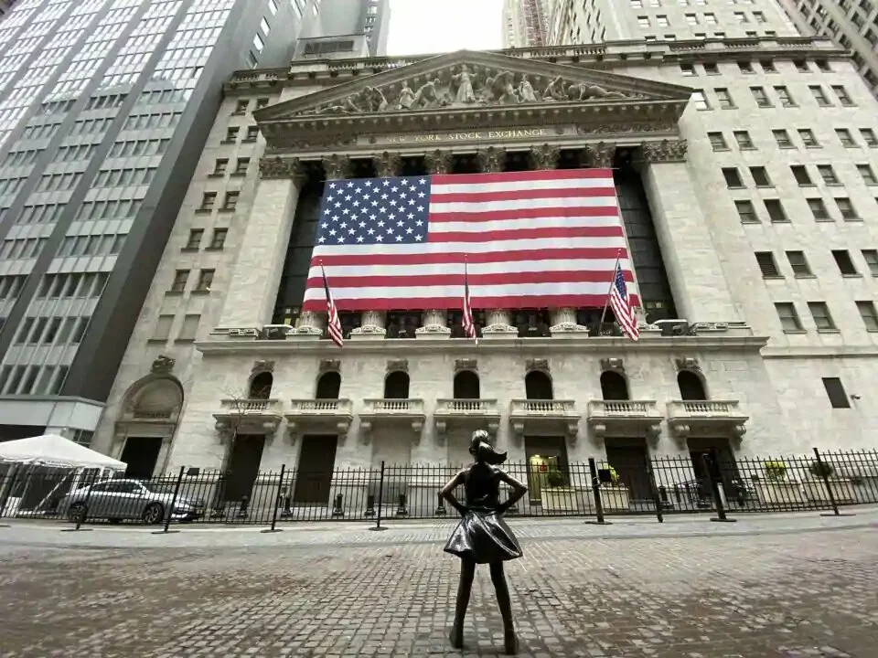 Flags fly at full staff outside the NYSE on April 09, 2020 in New York City. President Trump has ordered lowering the US flag at half-staff for three days the country’s Covid-19 death toll approaches the 100,000 mark.