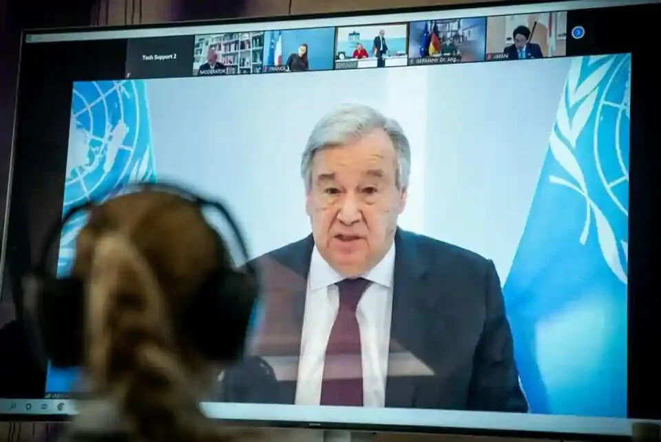 United Nations Secretary-General Antonio Guterres is seen on a video screen during a virtual climate summit, known as the Petersberg Climate Dialogue, in Berlin.