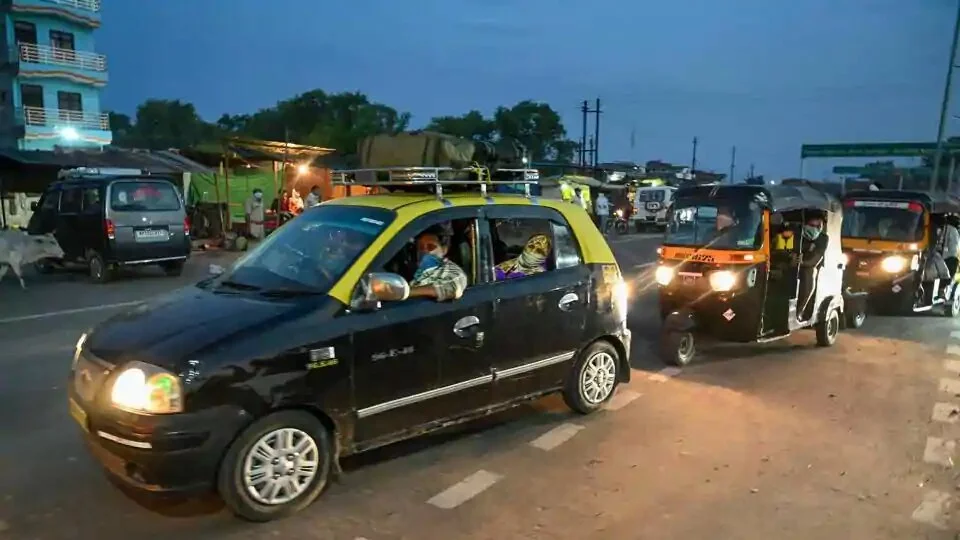 Migrants travelling via taxis from Mumbai ride towards their native places during the ongoing nationwide COVID-19 lockdown, at Uttar Pradesh- Madhya Pradesh Border, Chakghat in Prayagraj.