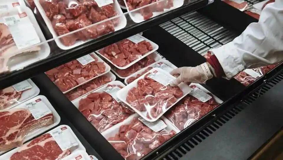 A worker restocks beef at a Stew Leonard