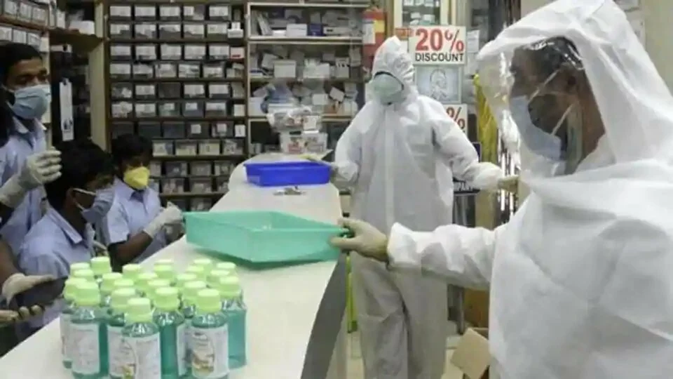 Pharmacy shop workers wear full protective gear during the nationwide lockdown to curb the spread of coronavirus in Kolkata.
