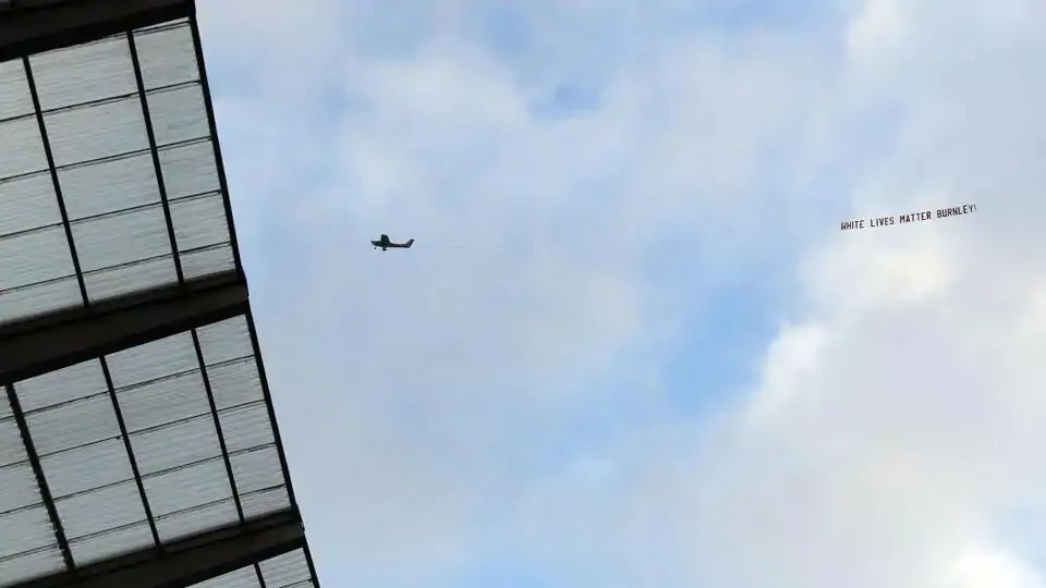 A plane towing a banner reading