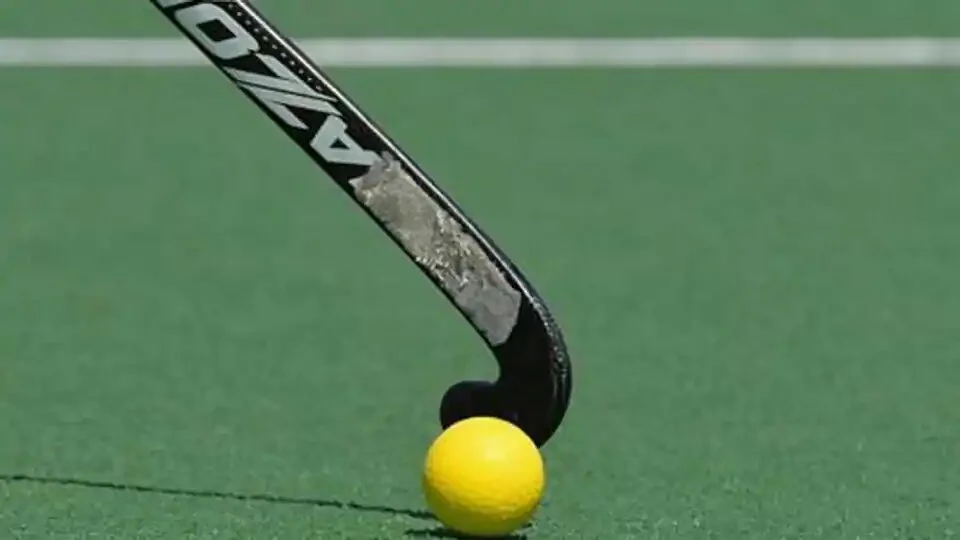 A field hockey stick hits the ball during the international men