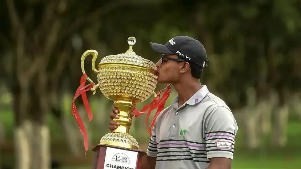 Indian golfer Viraj Madappa kisses the trophy after winning of the Take Solutions Masters, Asian Tour Championship held at the Karnataka Golf Association in Bengaluru on Sunday, Aug 12,2018.