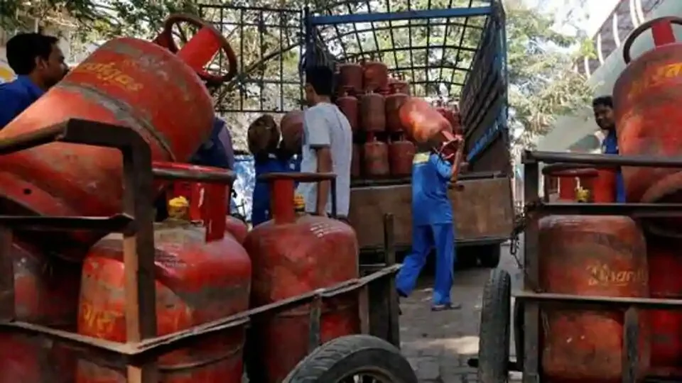 Workers load liquefied petroleum gas (LPG) cooking cylinders onto a supply truck outside a distribution centre in Mumbai.