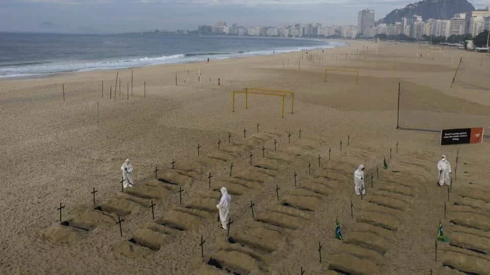 Activists in costume dig symbolic graves on Copacabana beach as a protest, organized by the NGO Rio de Paz, against the government