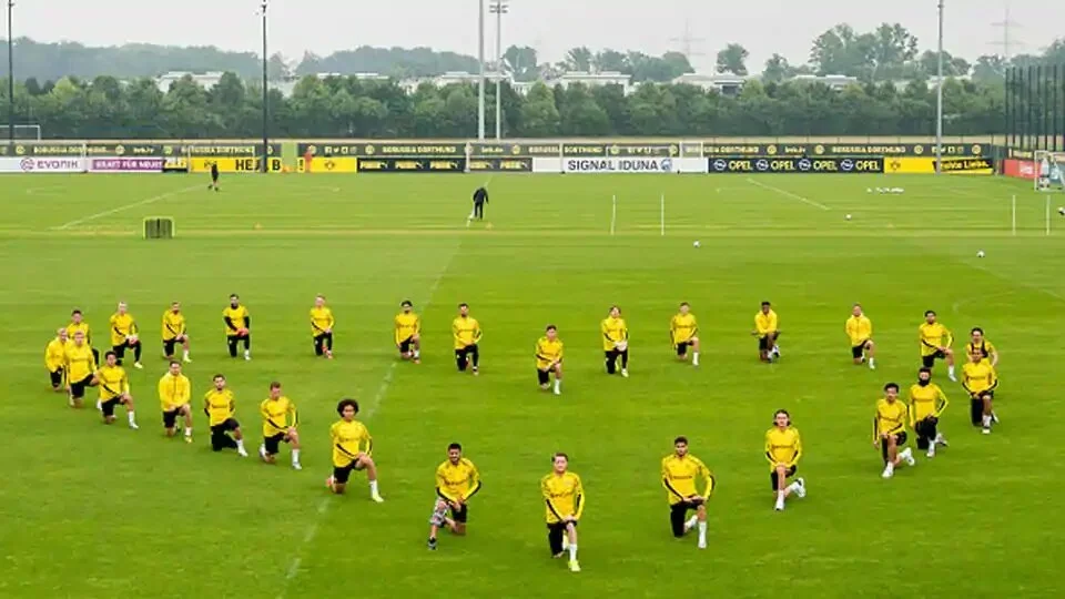 The players of Borussia Dortmund kneel down in support of the Black Lives Matter Movement during a training session.