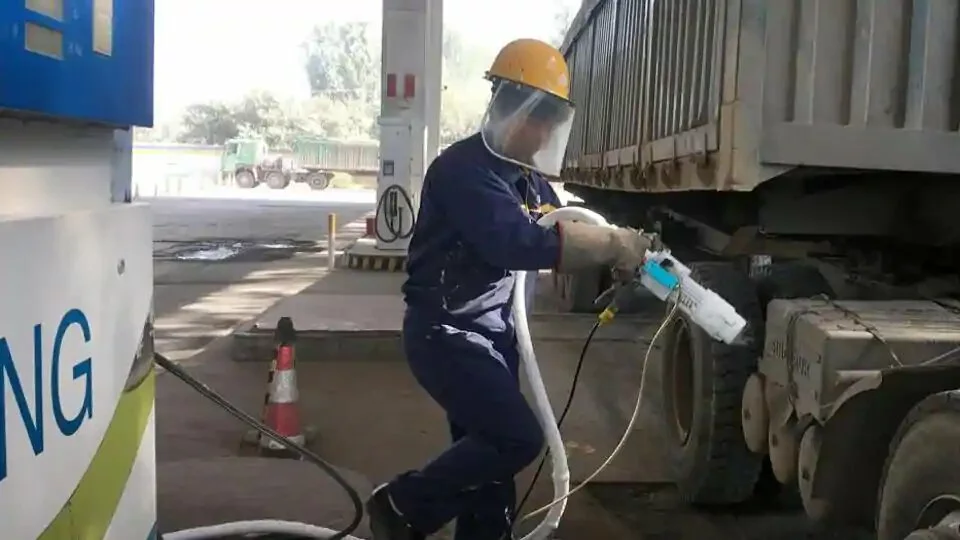A worker prepares to fuel liquefied natural gas (LNG) for a LNG truck at a gas station in Yutian county, China