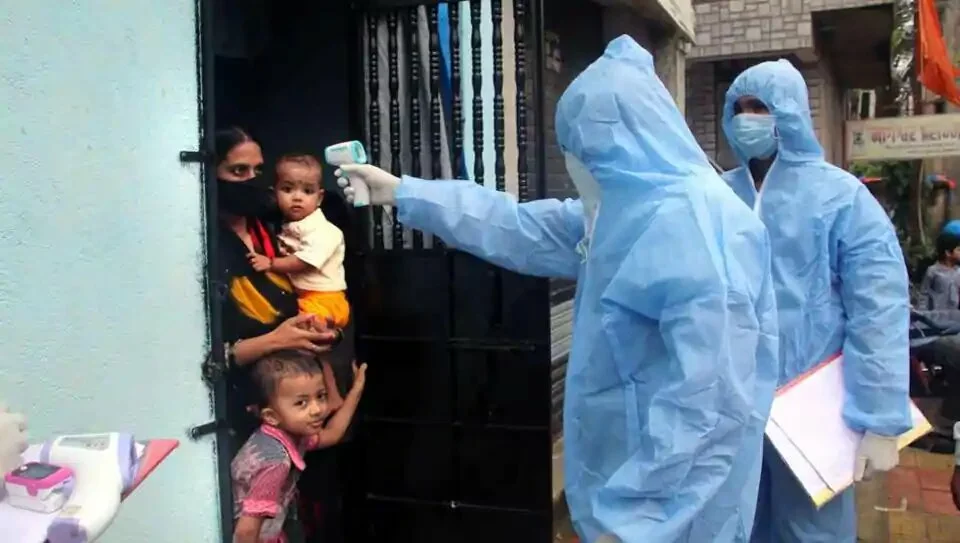 Health worker check temperature of a resident at Milind Nagar, Yogidham during Covid-19 pandemic in Kalyan, Mumbai on Tuesday.