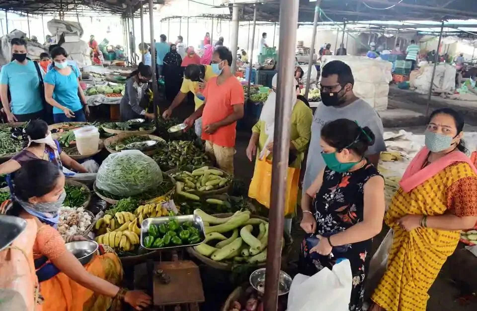 People buy vegetables from Wadgaonsheri vegetable market ahead of lockdown in Pune.