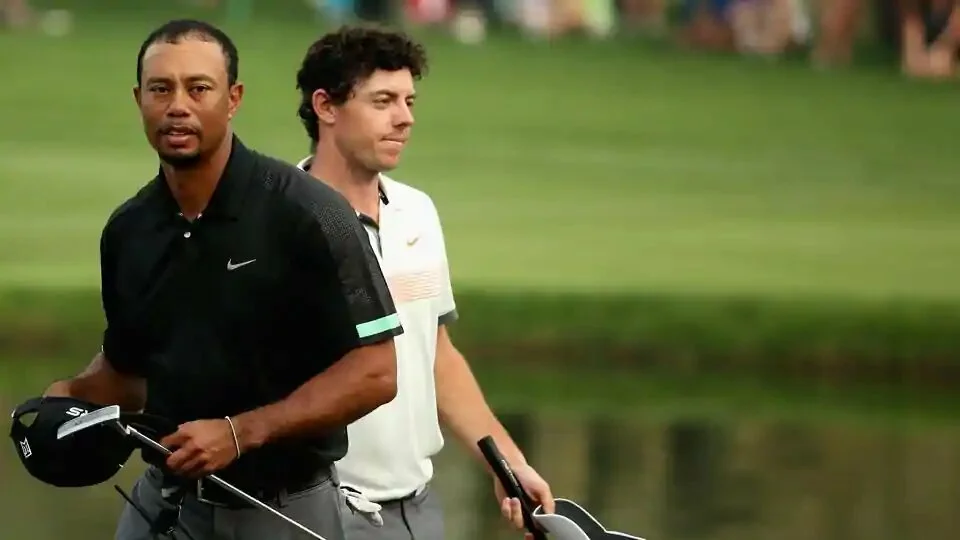 Rory McIlroy and Tiger Woods walk off the 18th green during the second round of the 2014 Omega Dubai Desert Classic.