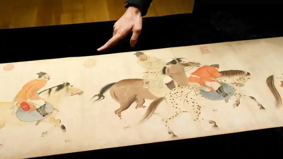 A staff member points to the Chinese classical painting