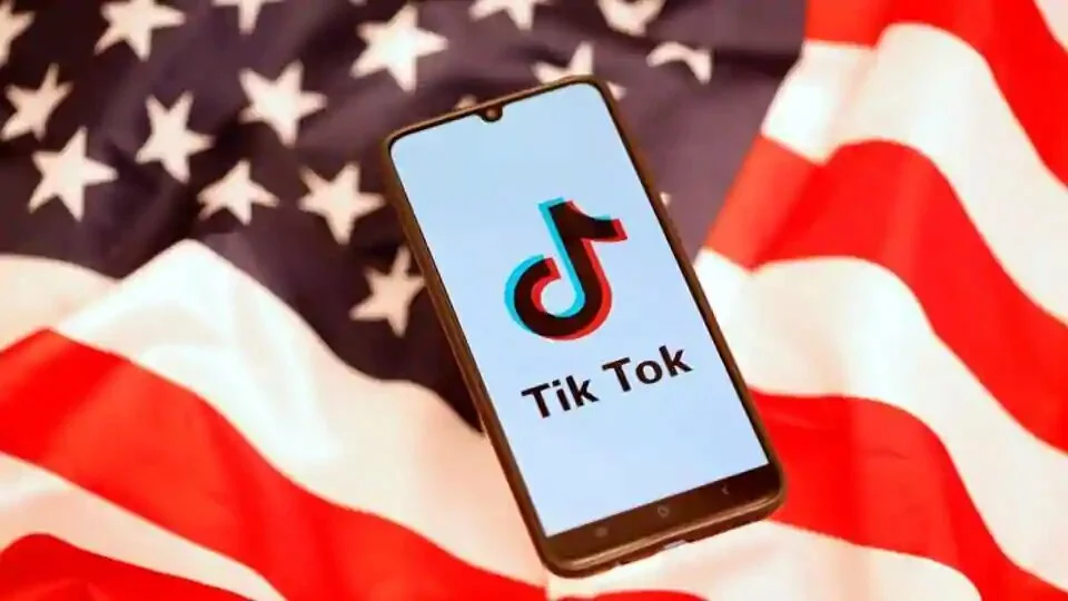 TikTok logo is displayed on the smartphone while standing on the US flag in this illustration picture.