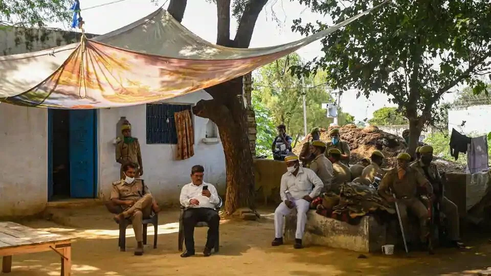 Police personnel deployed near the family home of the victim in Bool Garhi, Hathras, Uttar Pradesh.